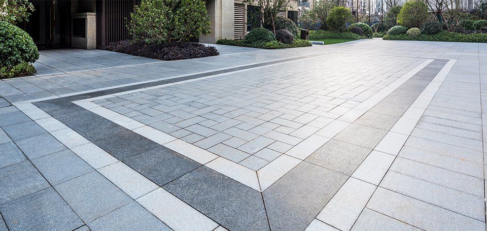 Applying a natural finish paving sealer to granite.