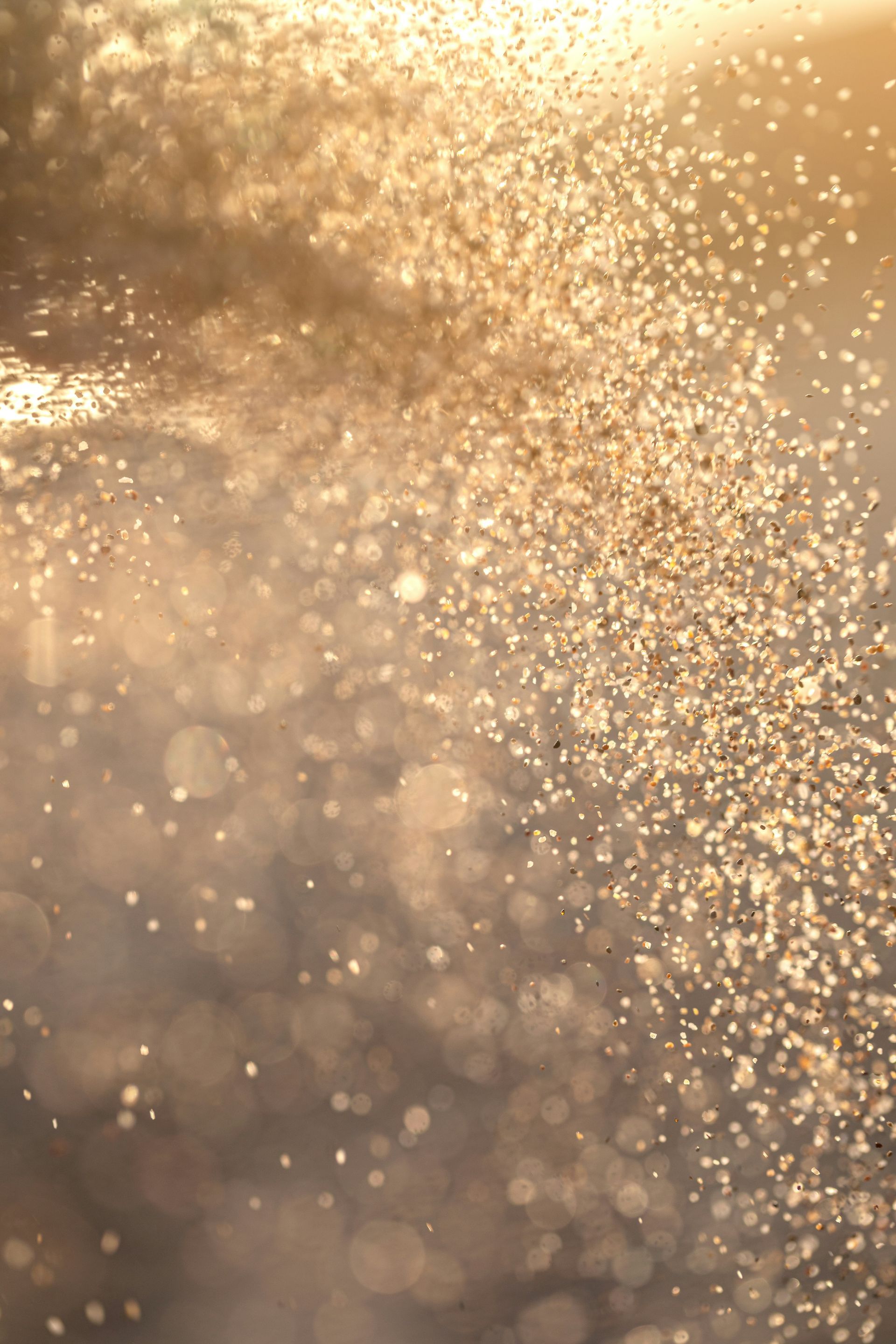 A close up of a shiny surface with a lot of sparkles coming out of it.