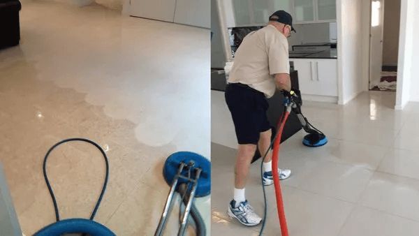 A Man is Cleaning a Tiled Floor With a Vacuum Cleaner — The Tile & Stone Specialists in Peregian Beach, QLD