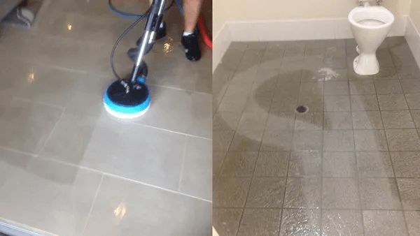 A Person is Cleaning a Tile Floor Next to a Toilet — The Tile & Stone Specialists in Peregian Beach, QLD