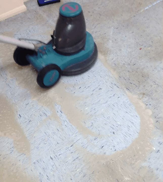 A Vacuum Cleaner is Being Used to Clean a Tile Floor — The Tile & Stone Specialists in Nambour, QLD