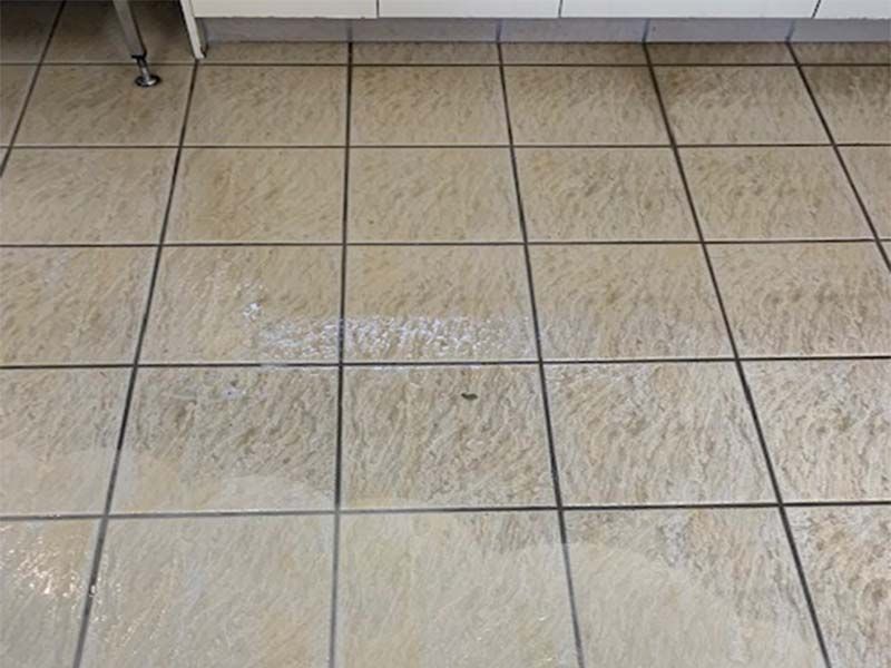 A Close Up of a Tiled Floor in a Kitchen — The Tile & Stone Specialists in Peregian Beach, QLD