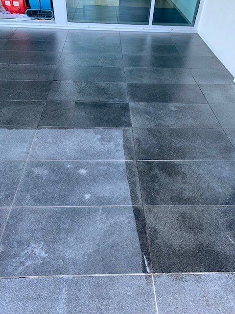 A Tiled Floor With a Sliding Glass Door in the Background — The Tile & Stone Specialists in Peregian Beach, QLD