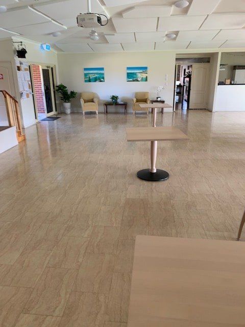 A Large Room With Tables and Chairs in It — The Tile & Stone Specialists in Peregian Beach, QLD