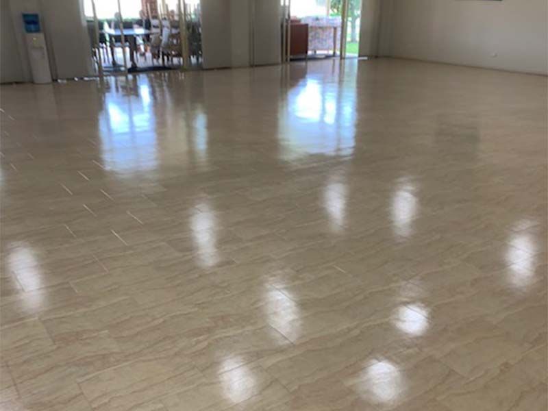 A Large Room With a Tiled Floor and a Reflection of Lights in the Floor — The Tile & Stone Specialists in Peregian Beach, QLD