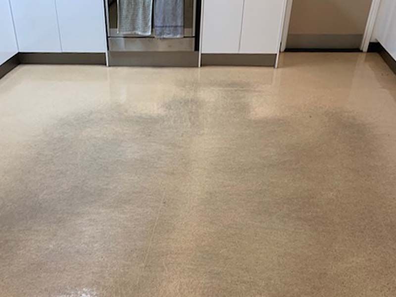 A Kitchen Floor With a Lot of Stains on It — The Tile & Stone Specialists in Peregian Beach, QLD