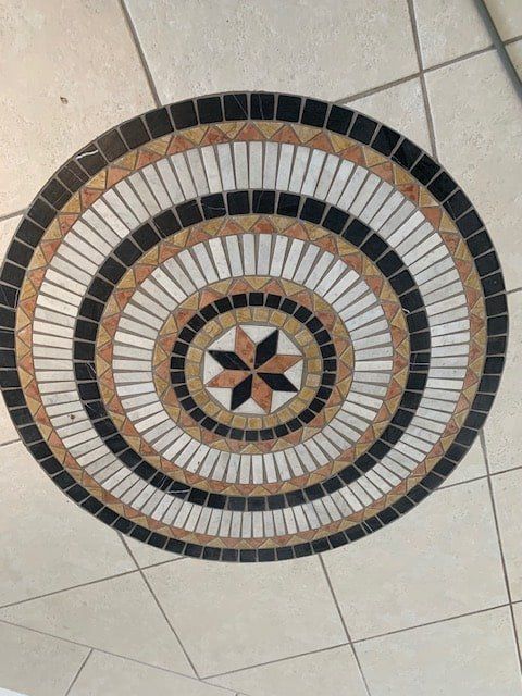 A Round Mosaic With a Star in the Center — The Tile & Stone Specialists in Peregian Beach, QLD