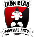 A logo for iron clad martial arts with a man on a shield.