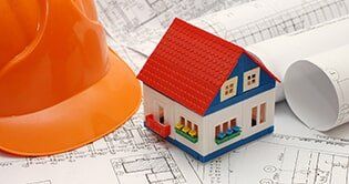Construction hat, blueprints and model house — Commercial Insurance in Fort Walton Beach, FL