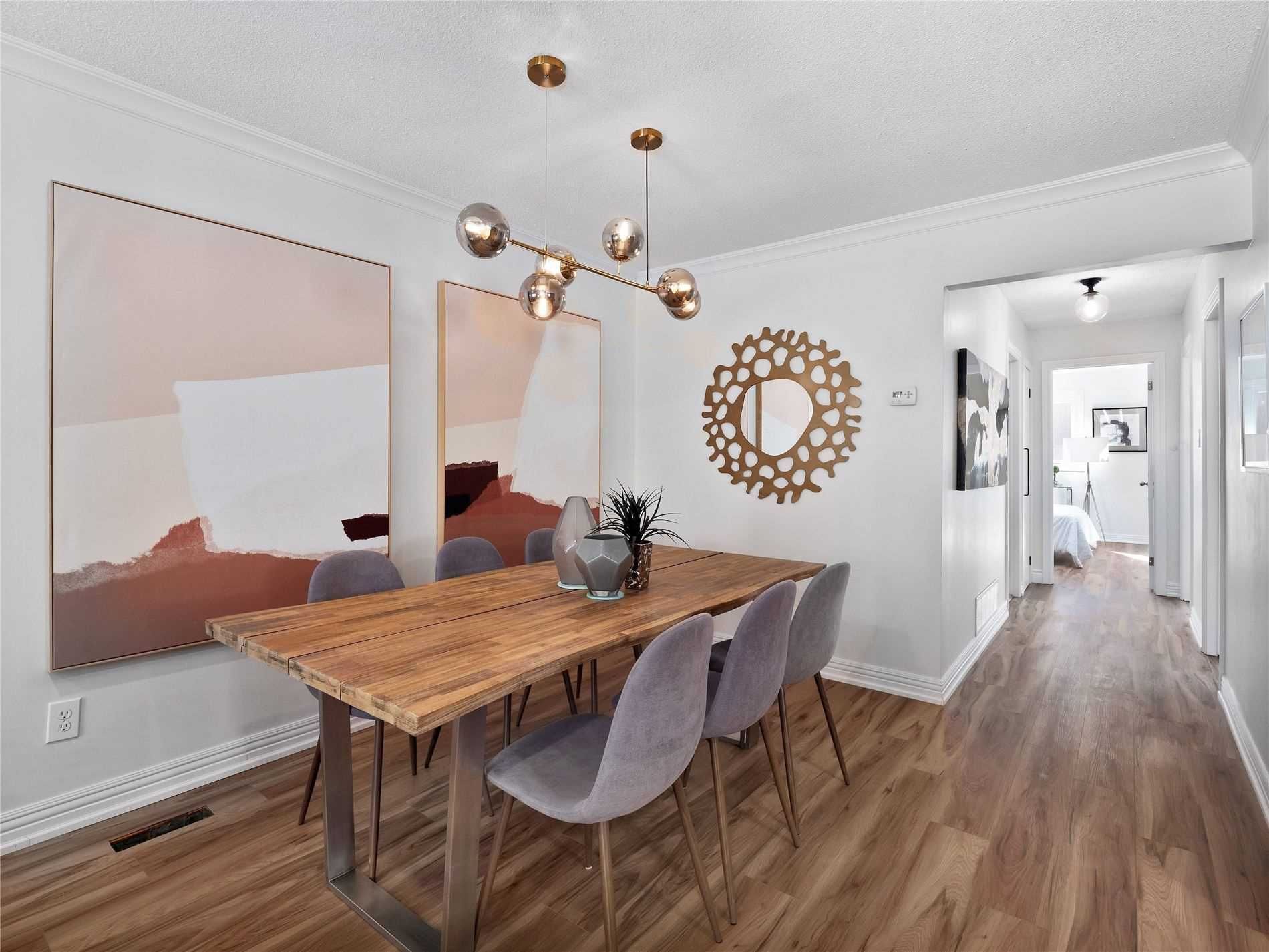 A dining room with a wooden table and chairs