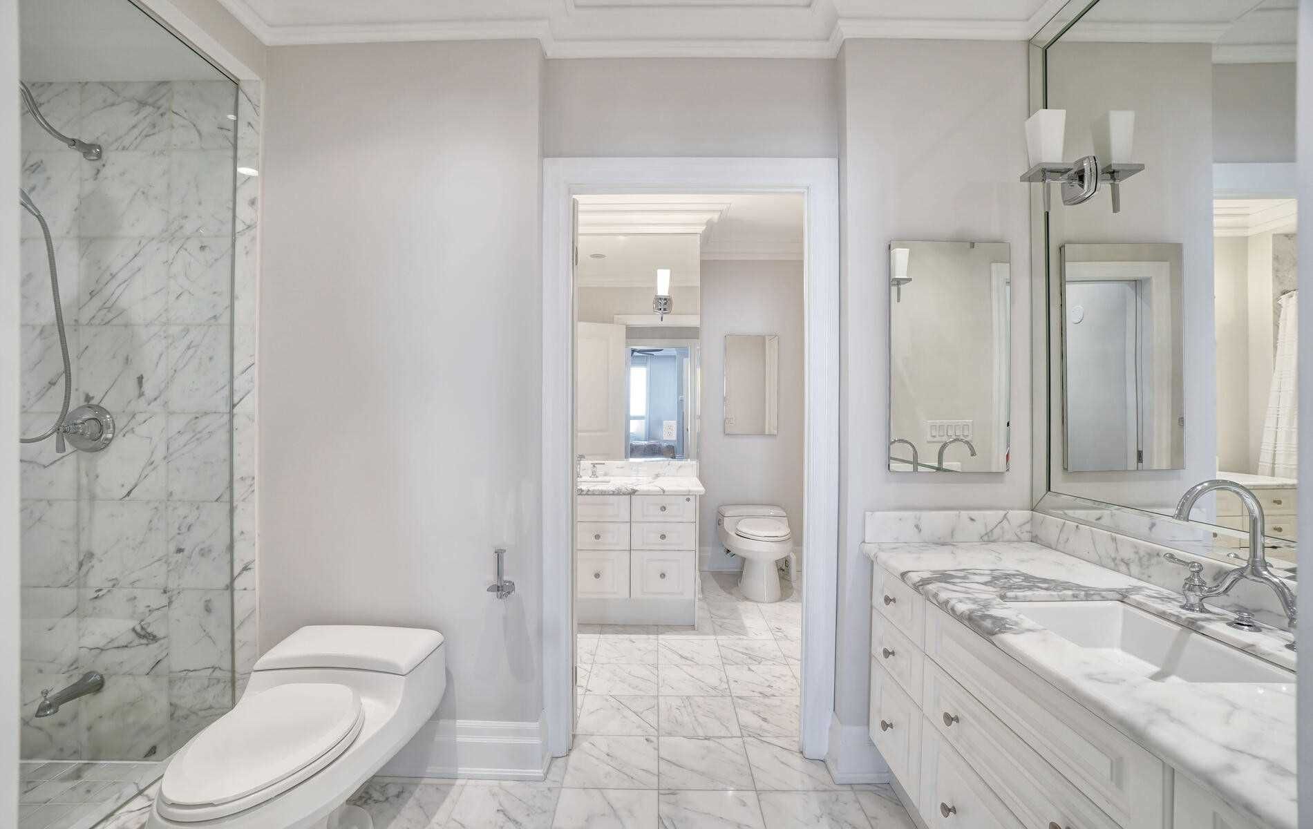 A bathroom with a toilet , sink , and shower.