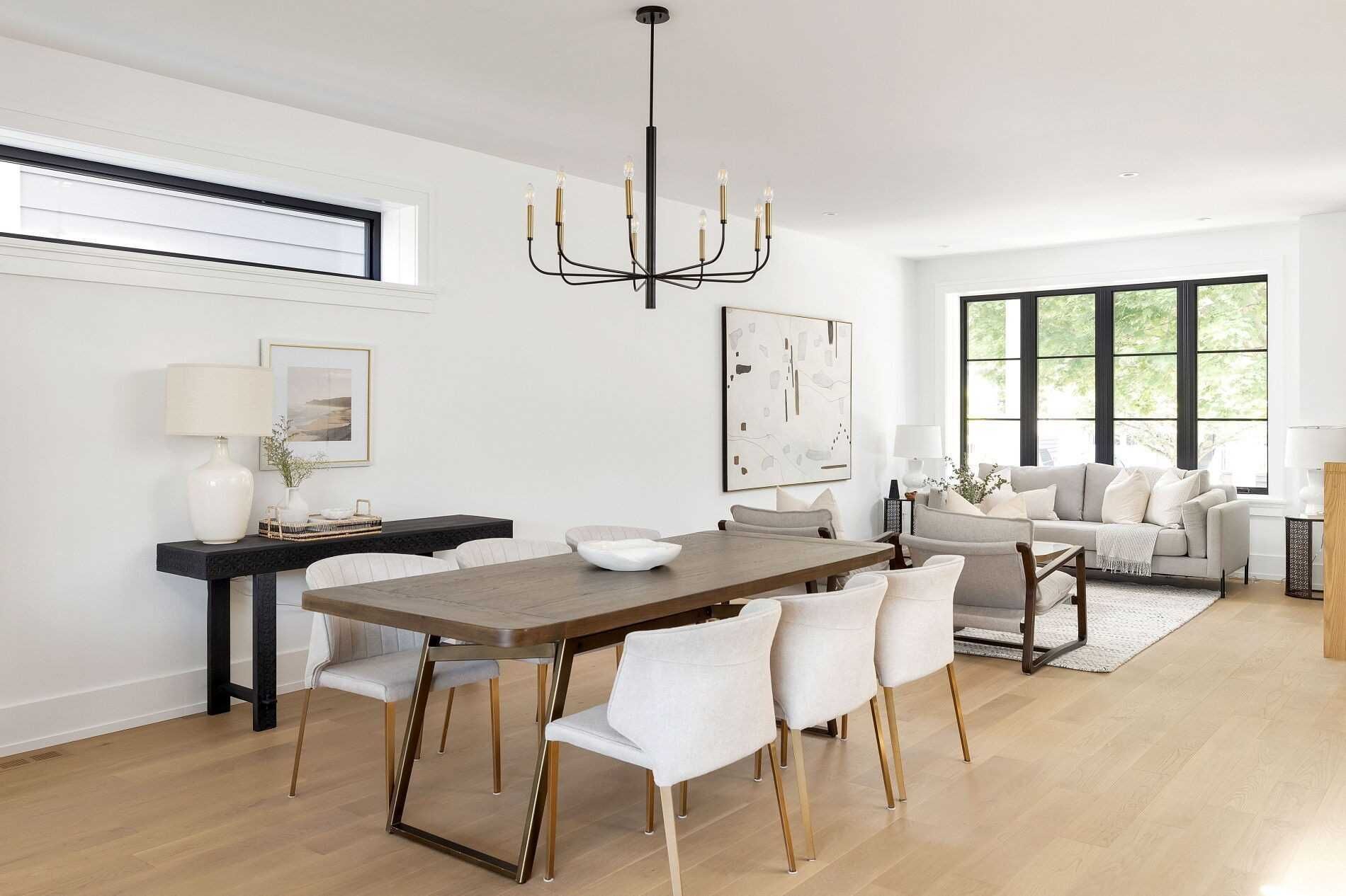 A dining room with a table and chairs and a chandelier.