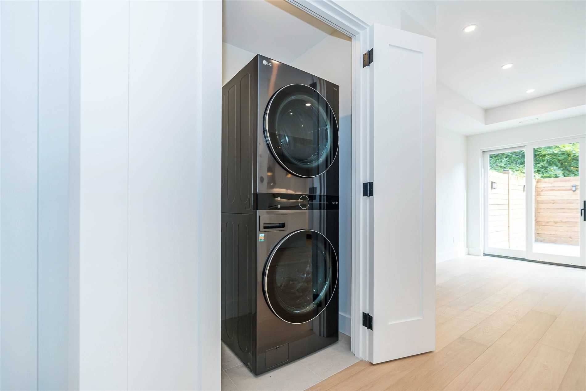 A washer and dryer are stacked on top of each other in a laundry room.