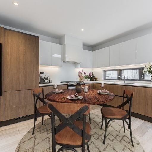 A kitchen with a round table and chairs in it