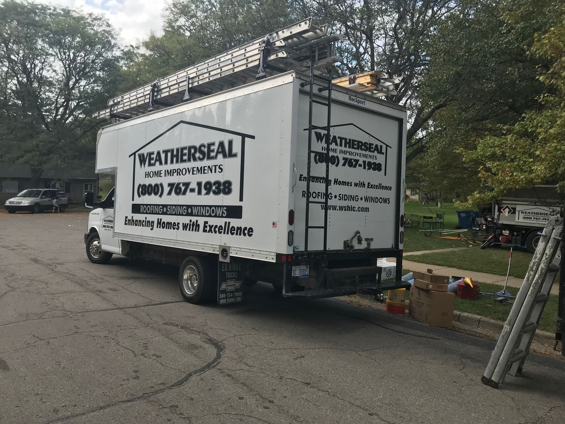 A weather seal truck is parked on the side of the road.