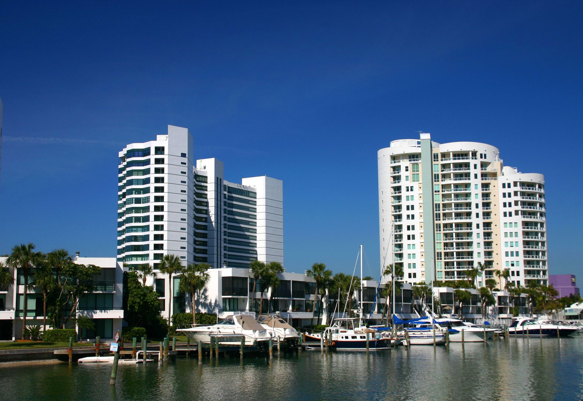 A row of tall buildings along a body of water