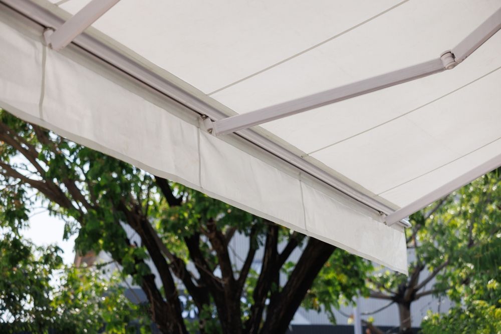 White Retractable Awning Extended, with Trees in Background — GV Blinds in Shepparton, VIC