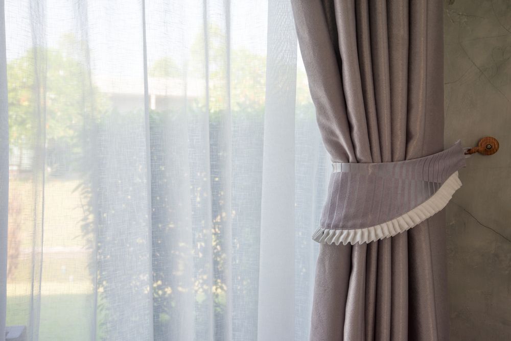 Sheer White Curtains Next to Draped Grey Curtain — GV Blinds in Shepparton, VIC