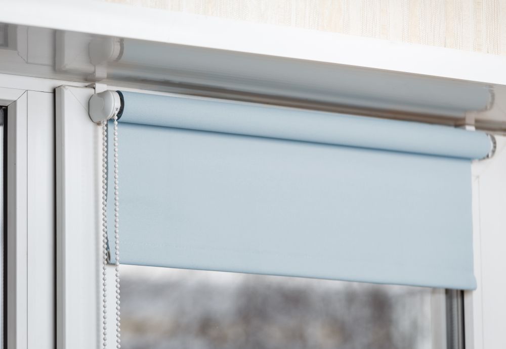 Light Blue Roller Shade Partially Covering a Window — GV Blinds in Echuca, VIC