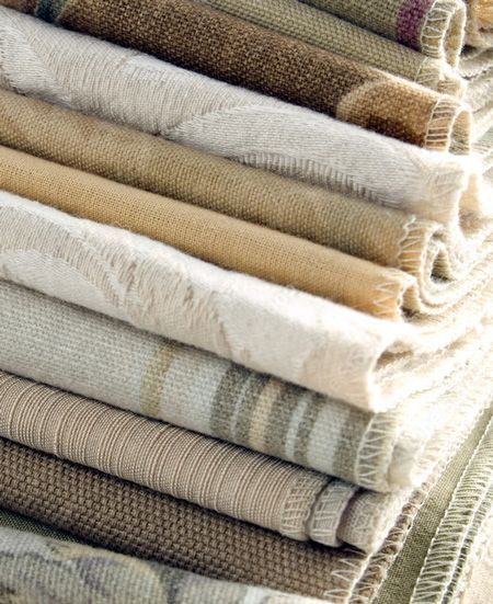 Stack of Rolled Fabric Samples in Neutral Shades, Varying Textures — GV Blinds in Shepparton, VIC