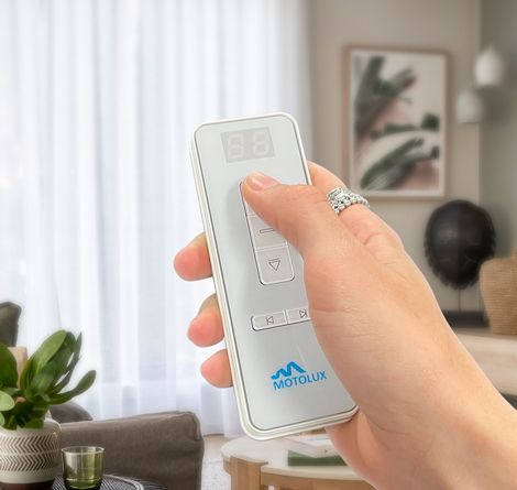 Hand Holding a White Remote Control — GV Blinds in Shepparton, VIC