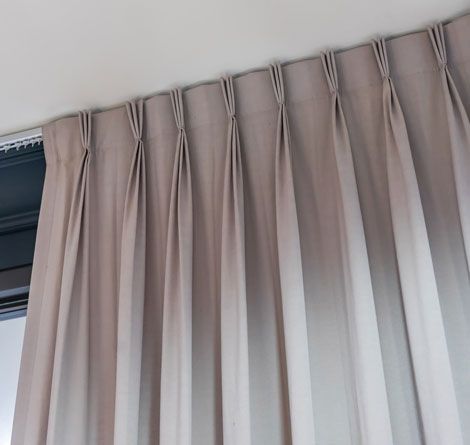 Beige Pleated Curtains Hanging From a Track on a Ceiling — GV Blinds in Shepparton, VIC