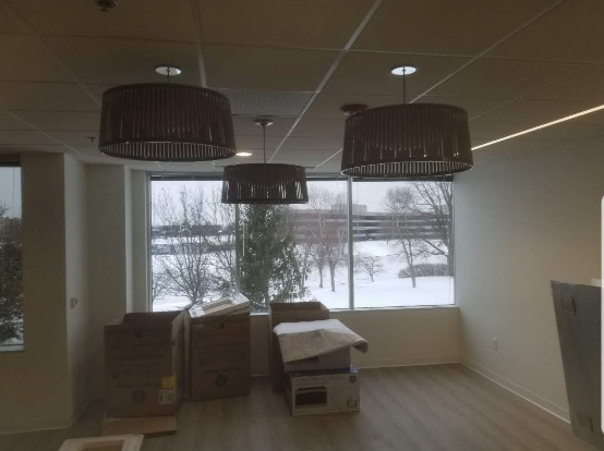 A room with a lot of boxes and a large window