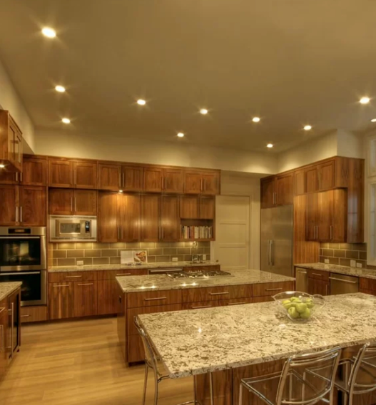 A kitchen with wooden cabinets and granite counter tops