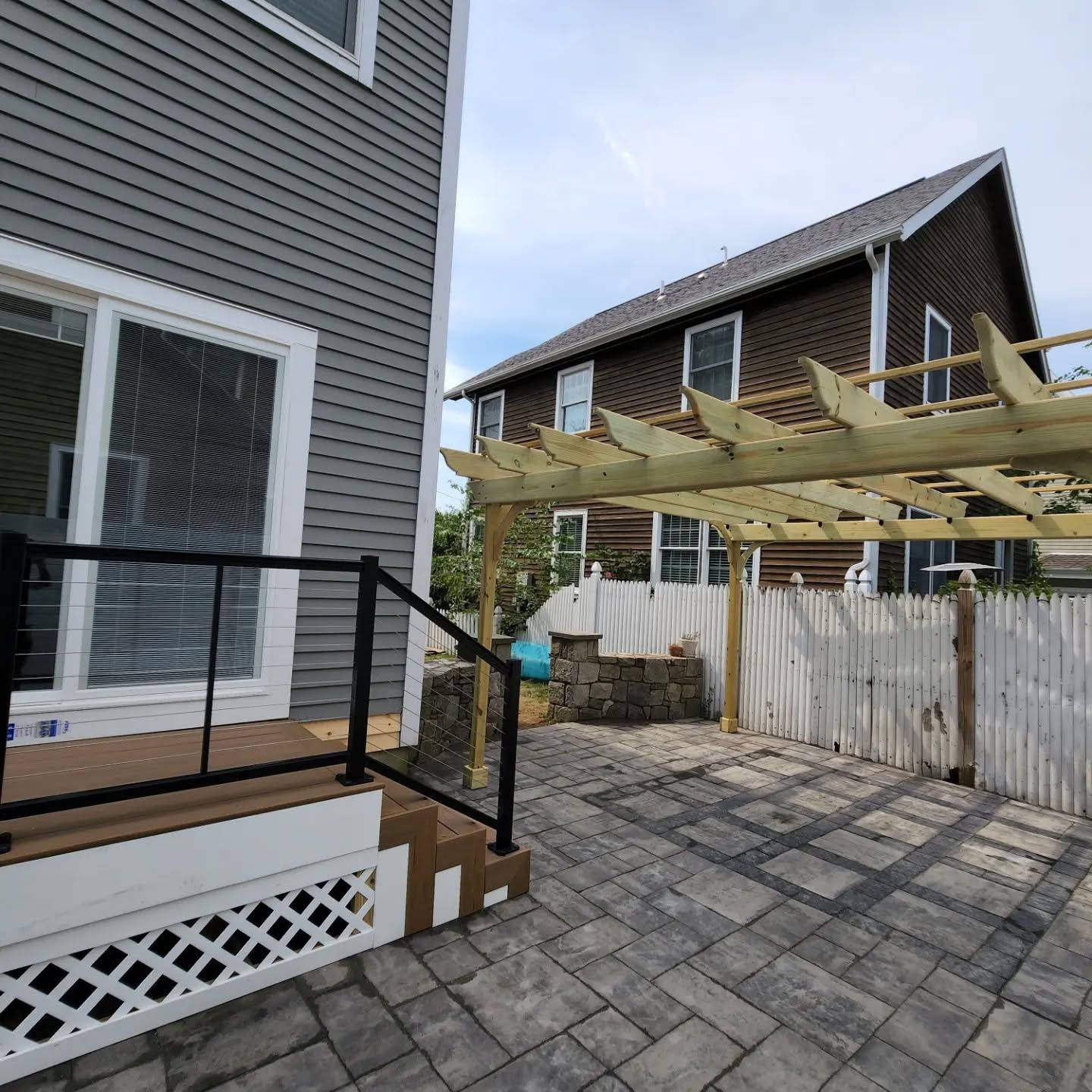 A house with a pergola in front of it