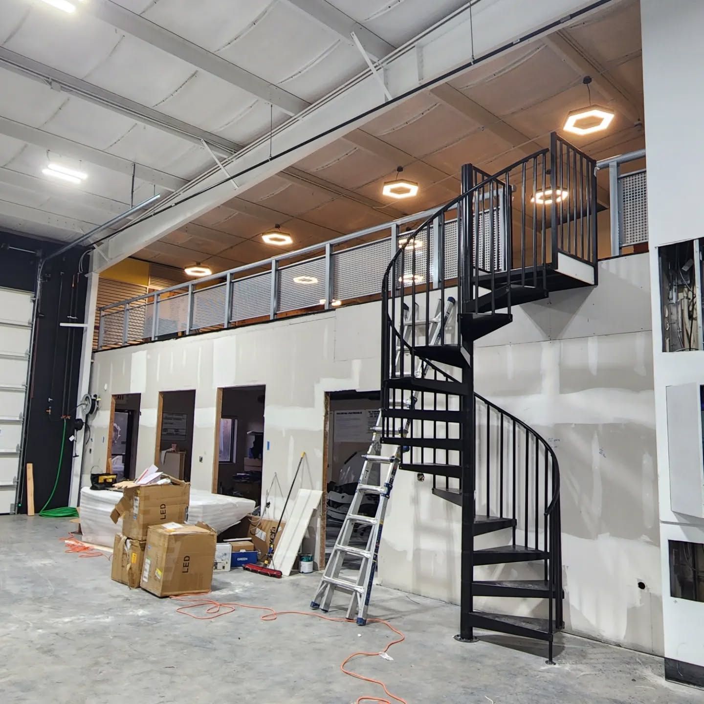 A spiral staircase is in the middle of a building