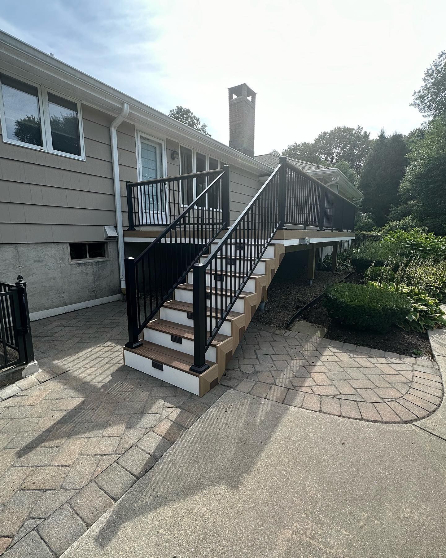 A house with a deck and stairs leading up to it.