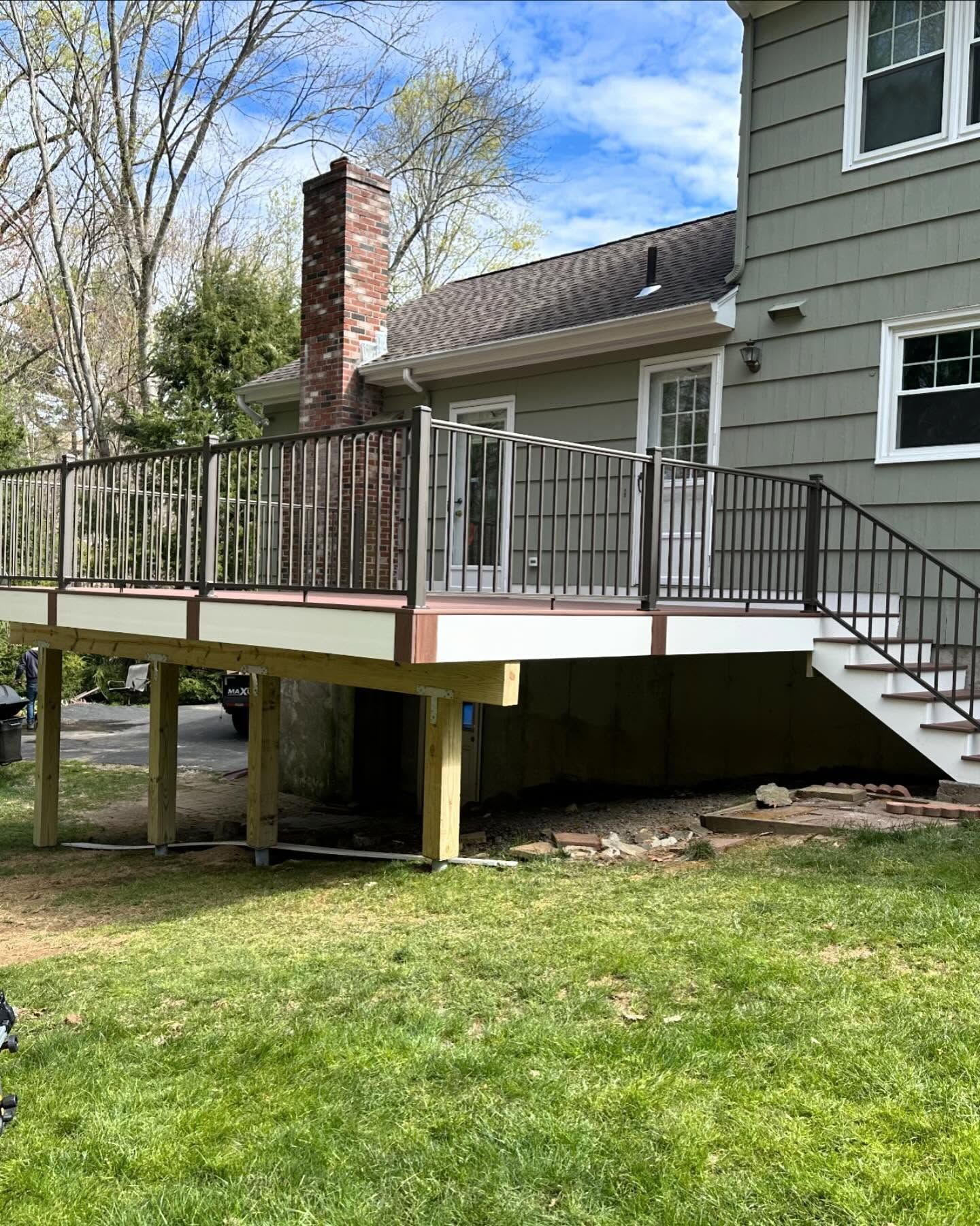 A house with a deck and stairs in the backyard.