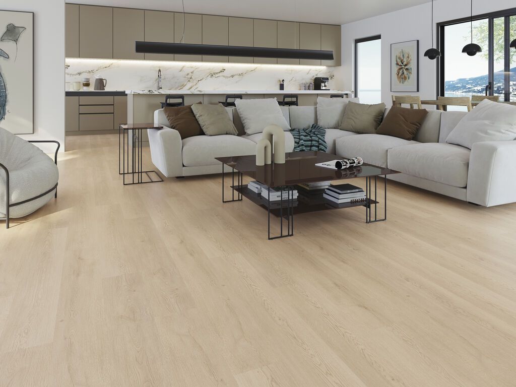 Soggiorno moderno a pianta aperta con divano componibile beige, tavolini neri e cucina sullo sfondo.
