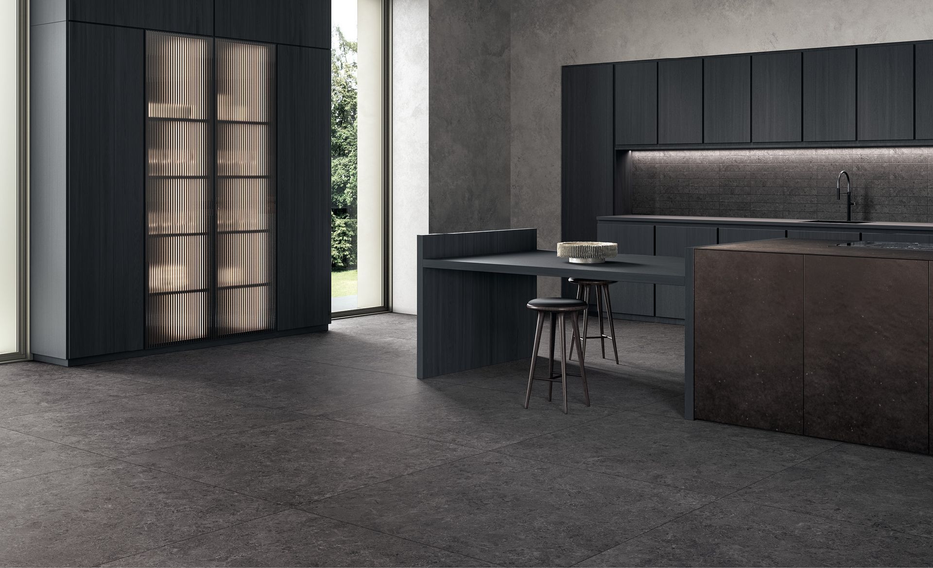 Cucina moderna e minimalista con mobili scuri, isola centrale e scaffalature a tutta altezza nei toni del grigio.