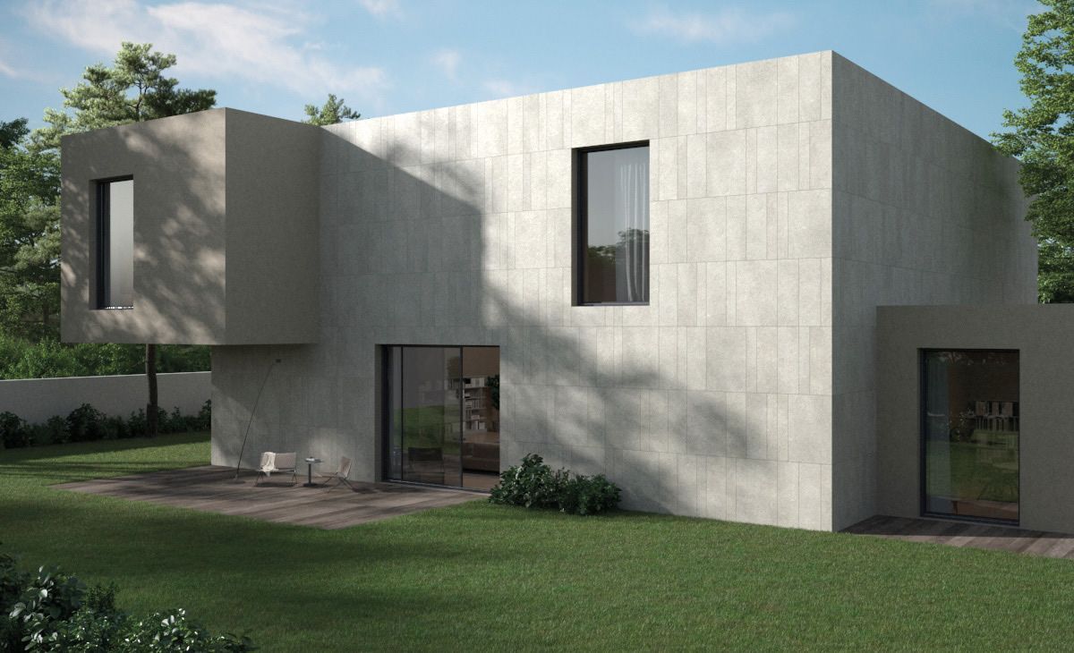 Casa moderna e minimalista in cemento con ampie finestre, tetto piano e un piccolo prato antistante.