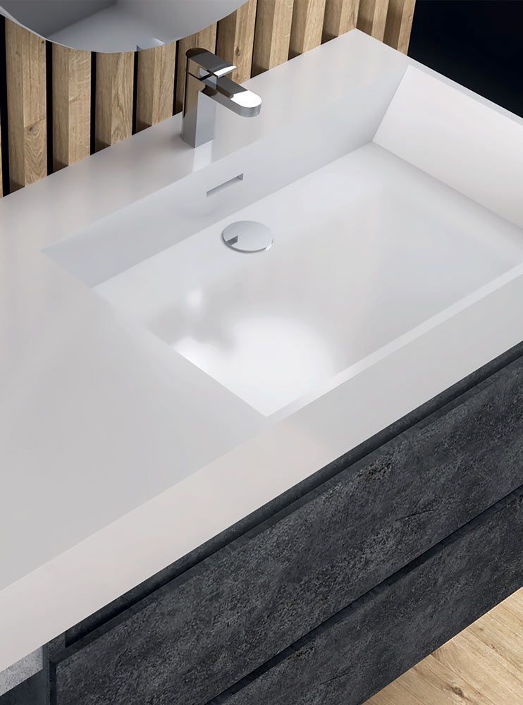 Lavabo moderno con vasca bianca, rubinetto cromato e mobiletto in legno scuro.