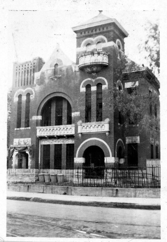 A black and white photo of a large brick building