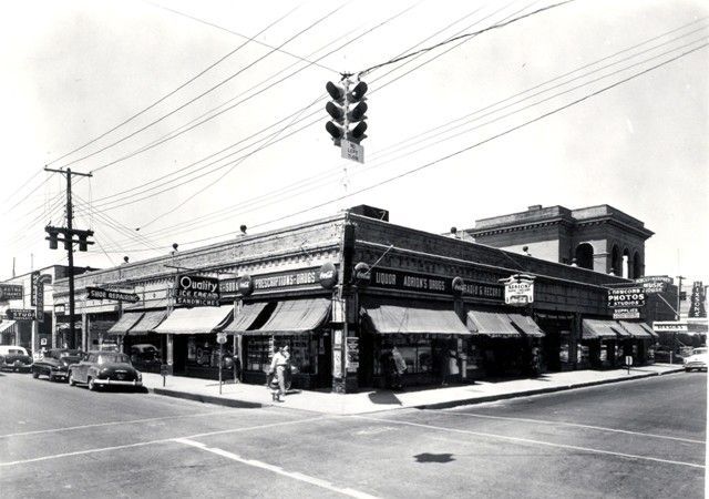 A black and white photo of a corner of a street