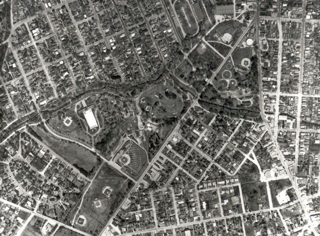 An aerial view of a city with a park in the middle of it.