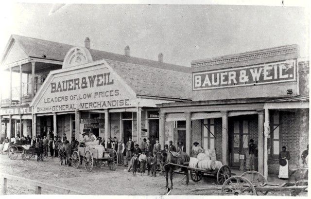 A black and white photo of a bauer & weil store