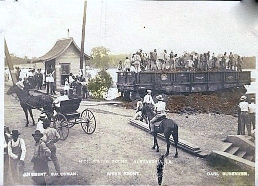 A black and white photo of a horse drawn carriage carrying people