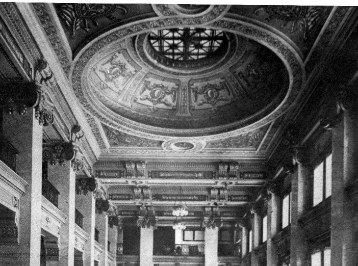 A black and white photo of a building with a dome ceiling