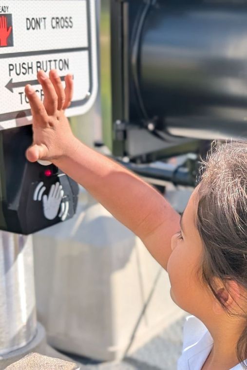 Child pressing crosswalk button