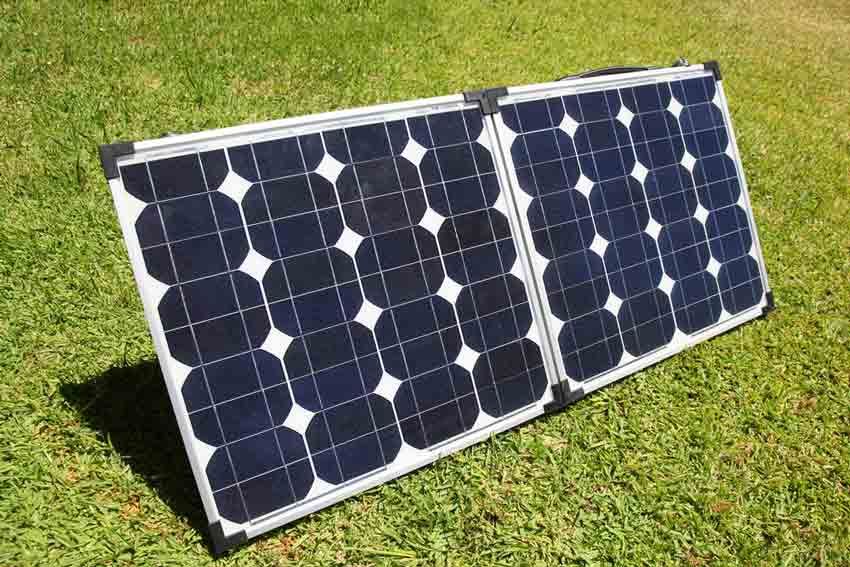 Small Off-grid Solar Panels On Green Grass