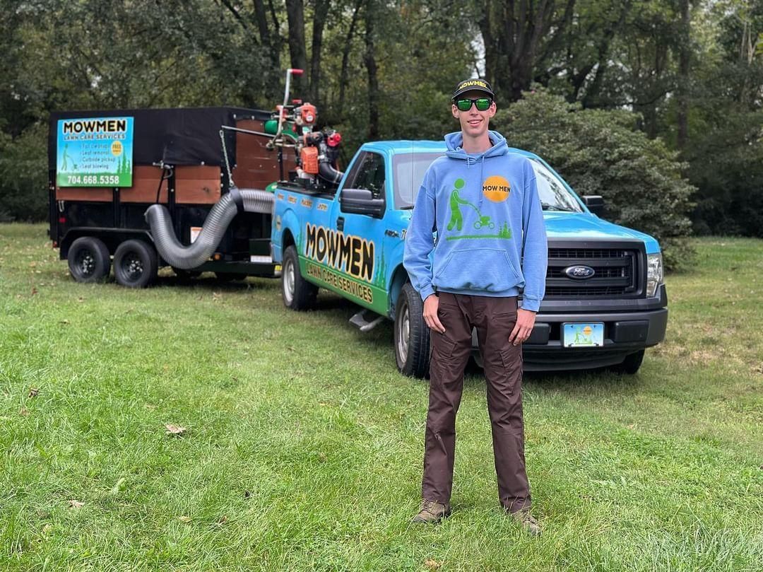 Mowmen lawn care owner with vehicle and lawn equipment