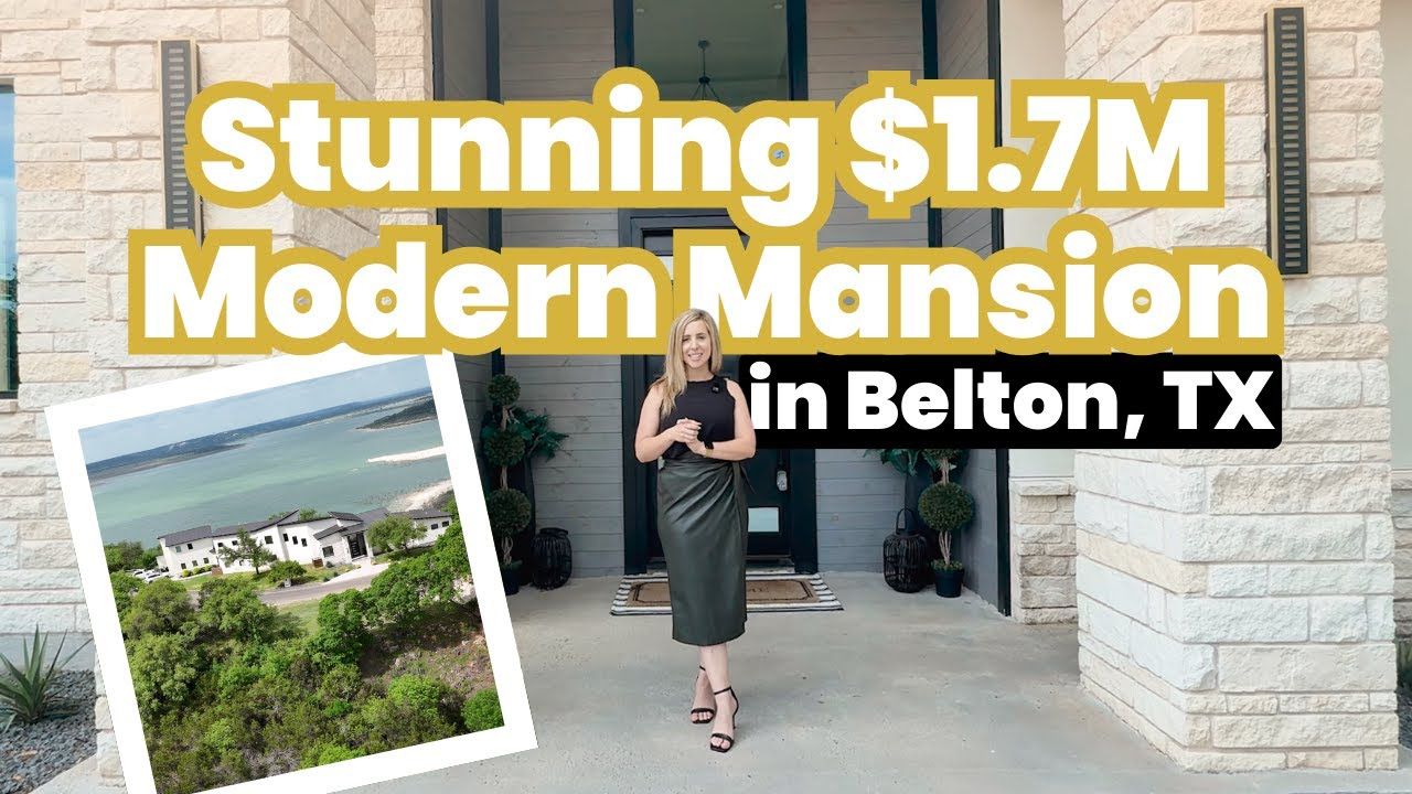 A woman is standing in front of a modern mansion in belton , tx.