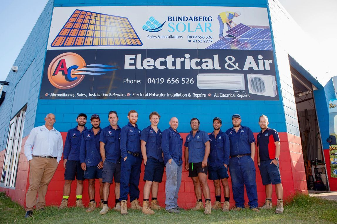 A Group of Men Standing in Front of A Building — AC Electrical & Air In Bundaberg Central, QLD