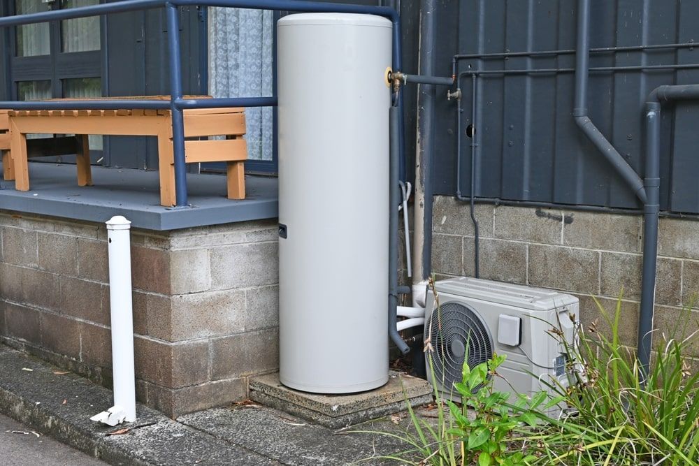 A large white water heater is sitting on the side of a building — AC Electrical & Air In Bundaberg Central, QLD