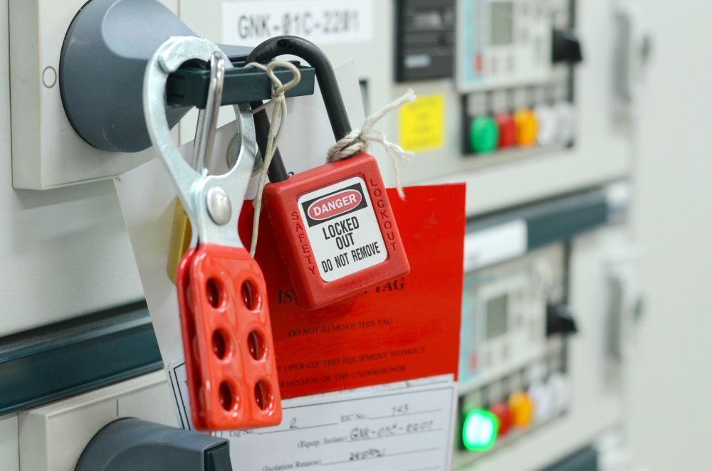 A Red Padlock Is Hanging On an Electrical Panel — Northern Testing in Winnellie, NT