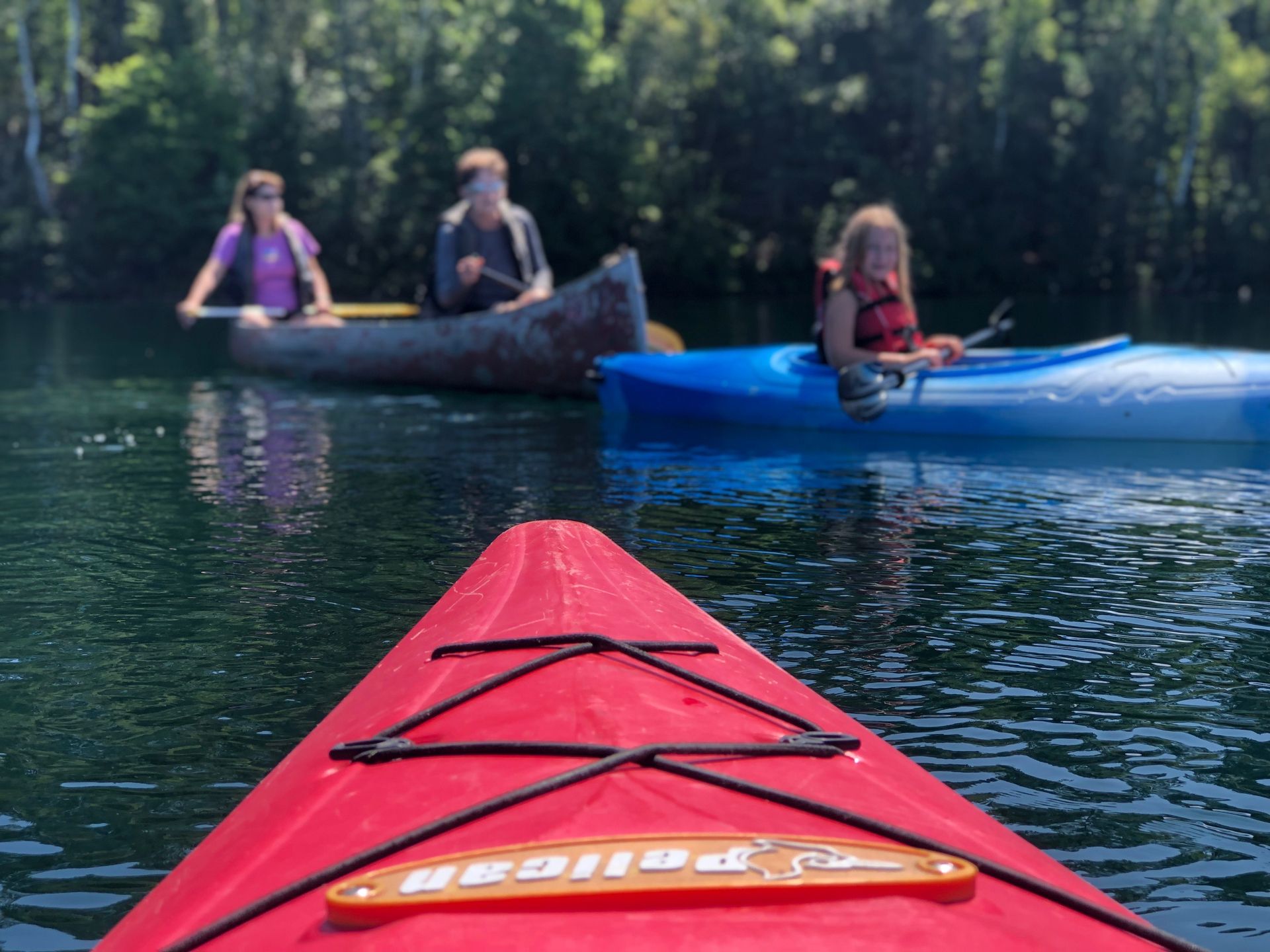 A red kayak with the word realized on the back